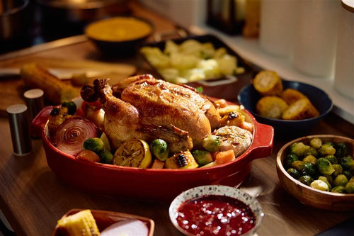 roast turkey surrounded by side dishes